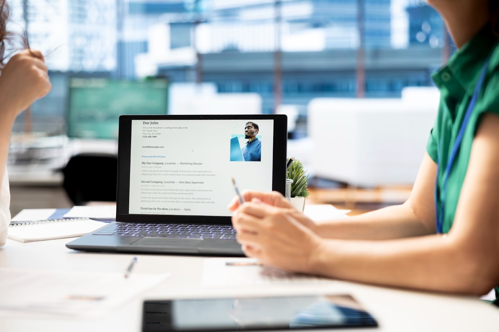 HR professional reviewing candidate resume on laptop through the top job portal in India - Jobber for verified hiring and recruitment